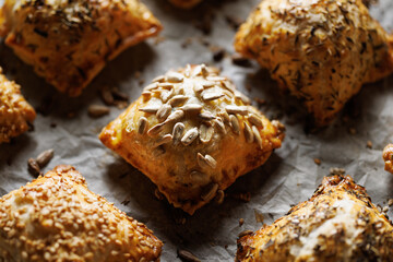 Puff pastry stuffed with spinach  and cheese sprinkled with mix of seeds, focus on the pastry inside. Delicious snack on the party.