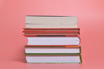 Books isolated on pink background