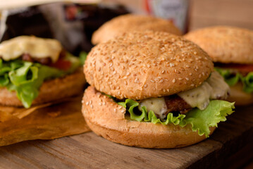 Yummy homemade burgers. Sesame bun, green salad, pork cutlet. 