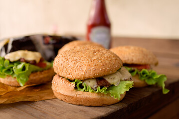 Yummy homemade burgers. Sesame bun, green salad, pork cutlet. 