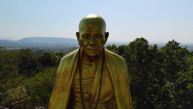 close view of a big monk statue close to highway in Chiang Mai, Lampang Road 
