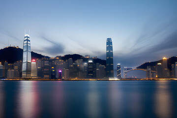 Obraz na płótnie Canvas Skyscraper and bridge in Victoria Harbor of Hong Kong city at night