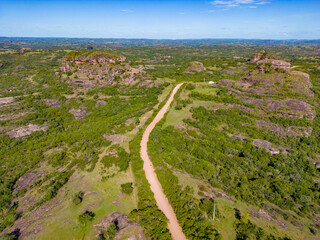 Fototapeta na wymiar Aerial view of dirty road, Geological formations and forest