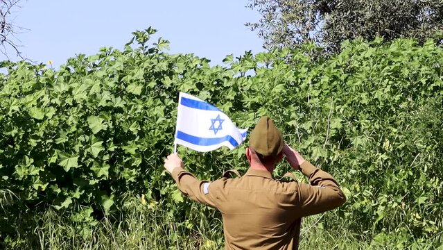 Israeli Soldier salutes the Israel flag. Concept: Israel Independence Day, Israeli soldiers, IDF. HD Slow Motion Video