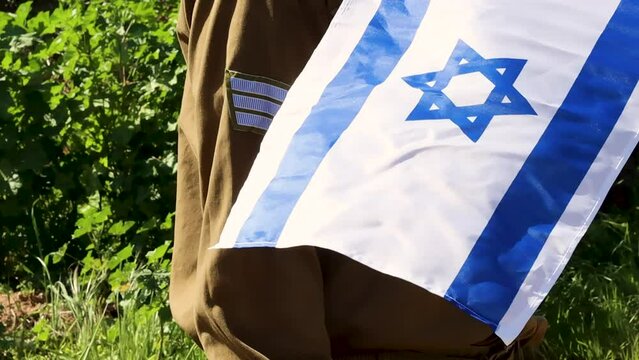 Flag of Israel and uniform of an Israeli soldier with a IDF sergeants patch. Concept slow motion video: IDF Army, Israeli Soldiers, IDF uniform
