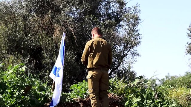 Israeli soldier sets the Israeli flag on a hilltop, kisses and salutes the flag of Israel. Concept: Israel Independence Day, Israeli soldiers, IDF, Memorial Day. HD Slow Motion Video