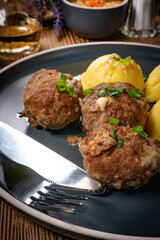 Meatballs with cheese served with boiled potatoes.