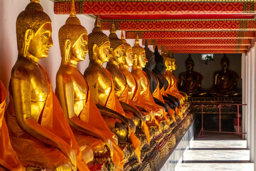 Fototapeta premium Golden Statues of Buddha in courtyard in the Royal Palace in Bangkok