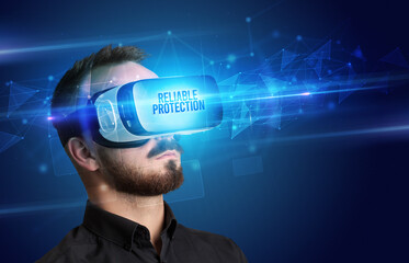 Businessman looking through Virtual Reality glasses, virtual security concept