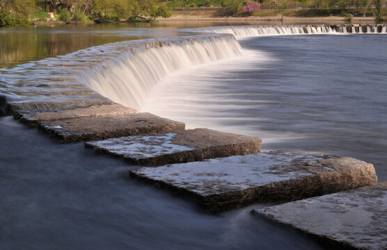 Small dam on a river, image with long exposure, water with movement in milk effect. elevation made with square stones