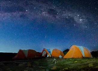 Deurstickers Kilimanjaro Orange tents illuminated before Mount Kilimanjaro and bright Milky Way