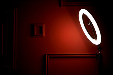 led ring lamp illuminates the red wall. LED ring light illuminates the red color wall