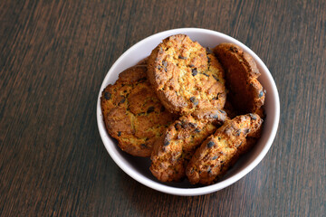 A bowl of oatmeal cookies on a table isolated, close-up 