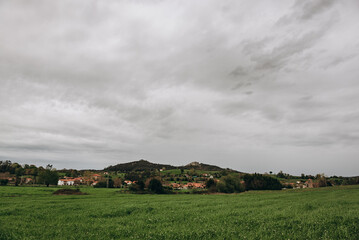 Obraz premium A view of a European village or city in a mountainous area. Buildings and housing in the foreground, and mountains in the background