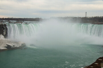 Niagara Waterfall flows over the edge with its huge Majestic power and green colors