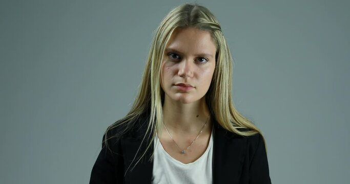 Young woman goes from serious to happy.