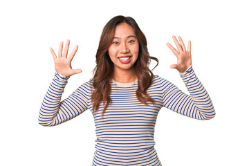 A young chinese woman showing number ten with hands.