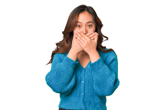 A Young Chinese Woman Covering Mouth With Hands Looking Worried.