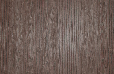 A close up of a wood grain with a dark brown background.