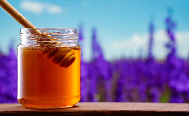  Jar of honey on nature background