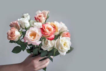 Female hand holds beautiful bouquet of roses. Mothers day, holiday decor, Flower delivery concept. Generative AI illustration