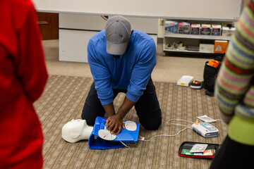 CPR training class by security guard in office