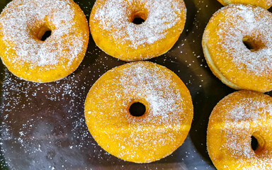 Chocolate and sugar donuts in supermarket bakery shelf in Mexico.