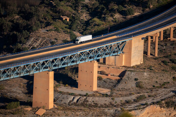 Refrigerated truck circulating on a highway on concrete and metal bridges, two different platforms...