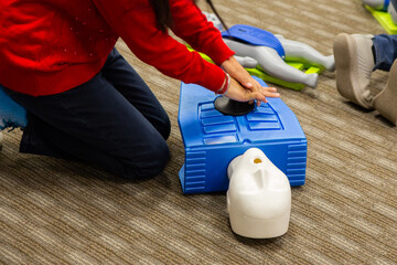CPR training class by security guard in office