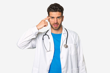 Fototapeta premium Young doctor man showing a disappointment gesture with forefinger.