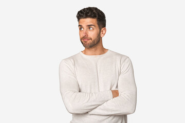Young handsome man isolated dreaming of achieving goals and purposes
