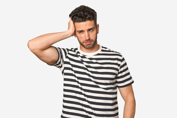 Fototapeta premium Young handsome man isolated tired and very sleepy keeping hand on head.