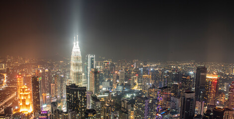Fototapeta na wymiar Night time view of Kuala Lumpur City skyscrapers with patronas towers lights