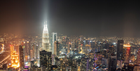 Obraz premium Night time view of Kuala Lumpur City skyscrapers with patronas towers lights