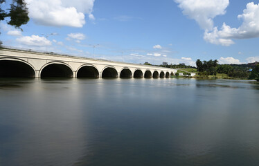 Fototapeta na wymiar Water crossing under the modern bridge with sunny day