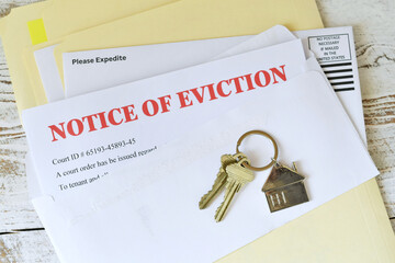 Set of house keys laying on a Eviction notice