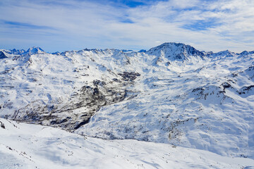 Town of Val Thorens in a snowy valley of the French Alps, as seen from the summit of La Masse mountain in winter