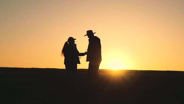 Agriculture. silhouette two farmers field with tablet. businessmen dialogue farmers wheat plantation. business partner grain sale deal sunset. senior farmers discussing harvest field. farming concept