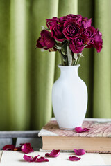 Bouquet of dried roses in a vase.