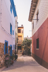 Fototapeta na wymiar Street with blue and red walls