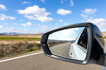 Road from a car rearview mirror
