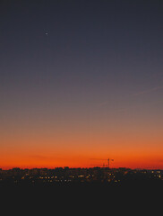 Nightfall with construction cranes