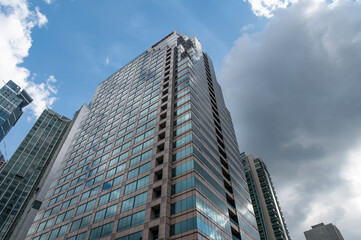 Fototapeta na wymiar Modern Business Hub building with dark clouds in background