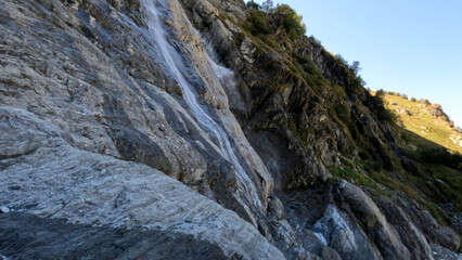 Fototapeta na wymiar pretty mountain ridge highland fast waterfall at summertime day - photo of nature