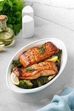 Salmon. Baked, roasted fish salmon steaks, slices. Grilled salmon,trout fillet fish in marinade with broccoli in baking dish. Diet, meal, dinner.