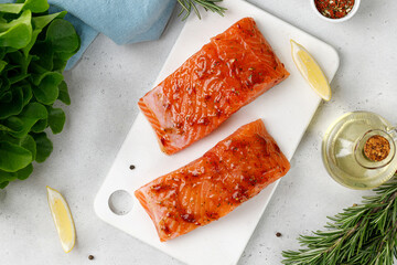 Marinated Salmon with sauce, red marinade, spicy. Fish steaks, slices. Raw uncooked salmon fillet...