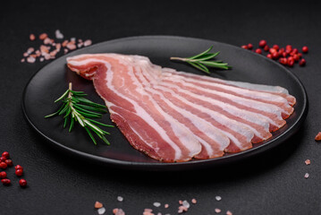 Delicious fresh pancetta with salt and spices cut into thin slices