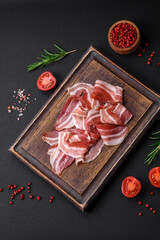 Delicious fresh pancetta with salt and spices cut into thin slices