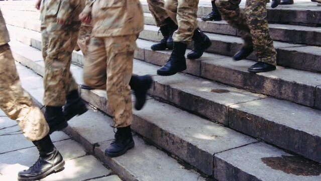a group of young cadets descending the steps in the park, slow motion footage