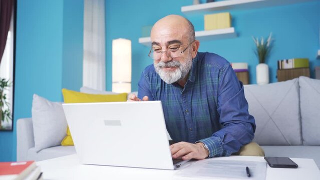 The cute old man who sees his grandchildren on Facetime is happy.
Happy and cheerful grandmother talking facetime on laptop at home and cheering up with grandchildren.

